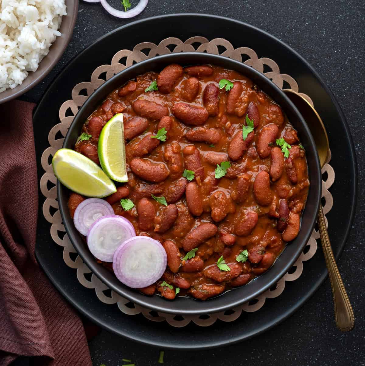  A pot of simmering Rajma Masala curry with visible spices and rich, thick gravy.