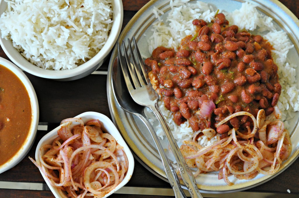A delicious serving of Rajma Chawal with rich curry and basmati rice on a white plate.